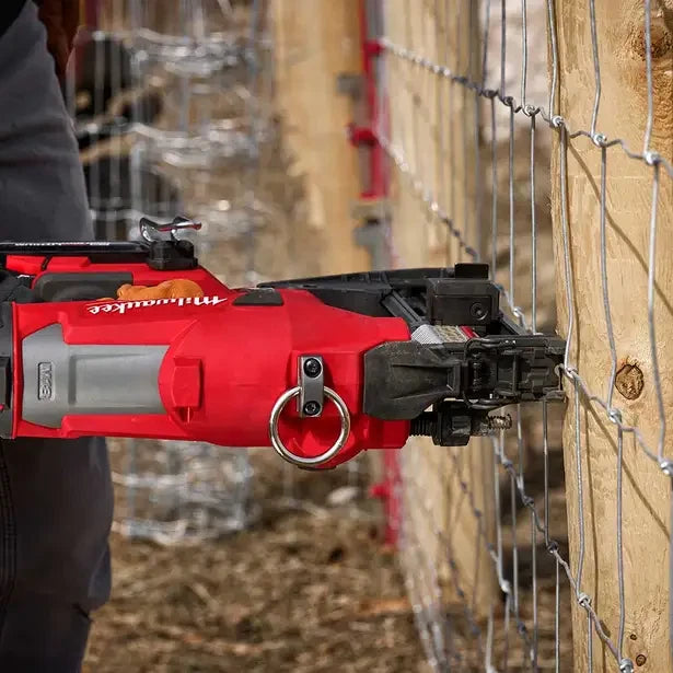 Milwaukee M18 fencing stapler in use on a fence